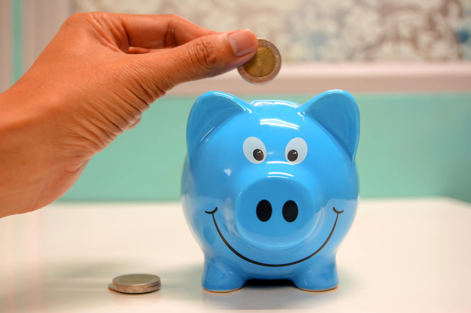 personne mettant la piece dans une tirelire Une tirelire qui représente l'accompagnement financier que Co-opt peut apporter à votre entreprise